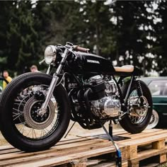 a motorcycle is parked on a wooden platform