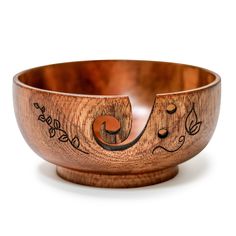 a wooden bowl with designs on it