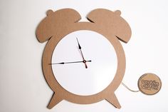 a clock made out of cardboard with a sticker on it