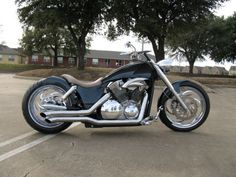 a black and silver motorcycle parked in a parking lot