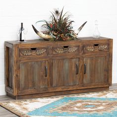 a wooden cabinet with two doors and three drawers on top of it next to a rug