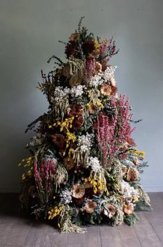 a christmas tree made out of dried flowers