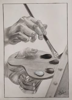 a pencil drawing of hands holding a paintbrush over a wooden table with seashells on it