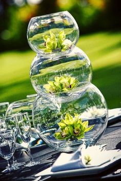 there are three vases with flowers in them on top of the table at this wedding reception