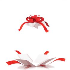 an open gift box with red ribbon and bow on top, flying through the air