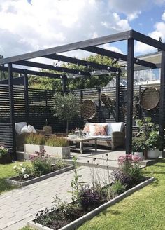 an outdoor patio area with seating and plants