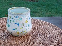 a cup sitting on top of a wicker table