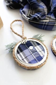 three plaid ornaments are hanging from twine