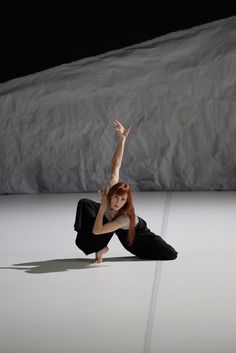 a woman is doing a handstand on the floor