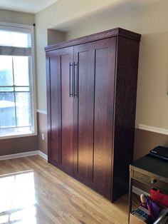 a large wooden cabinet sitting in the corner of a room