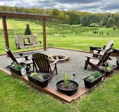 an outdoor patio with chairs and potted plants on the ground in front of it