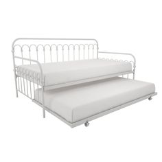 a white metal daybed with two mattresses