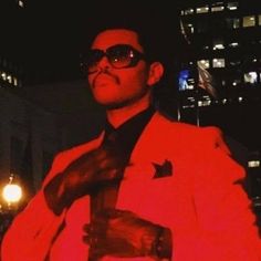 a man in a red suit and sunglasses