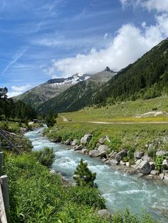 a river running through a lush green valley