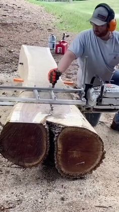 a man using a chainsaw to cut wood