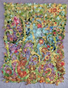 a quilt made with buttons and flowers on a purple background, in the shape of a square