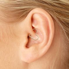 a woman's ear is shown with an open heart