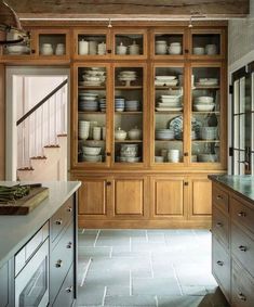 a kitchen filled with lots of wooden cabinets