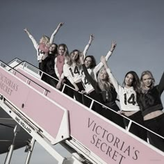 a group of women standing on top of a roller coaster