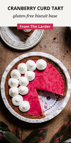 a pie on a table with the text cranberry curd tart gluten - free biscuit base from the larder