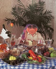 a stuffed animal sitting at a table covered in food