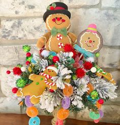 a teddy bear is sitting on top of a christmas tree decorated with candy canes