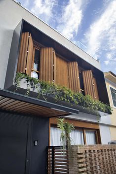 an apartment building with wooden shutters and plants on the balconies