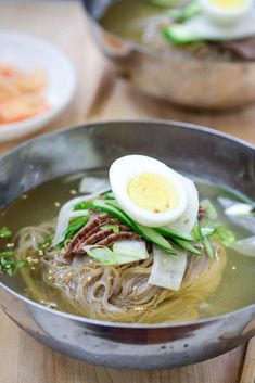 a bowl filled with noodles and an egg on top