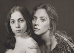 two women are posing for the camera with their heads close to each other and one has her eyes closed