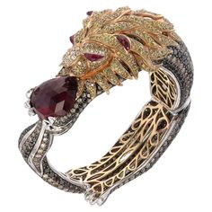 Sauvage Collection- One of a kind The exquisite stout-hearted lion bangle, adorned with a 19.15-carat rubellite, infuses the wearer's personality with unparalleled value. The lion’s head is embedded with a 6.77-carat fancy yellow diamond, creating charismatic spells around your wrist. The impressive 18.39-carat black diamond captures the essence of divine radiance and sparkles like a goddess. Elegantly followed by 19.66 carats of white diamonds, that reflects royalty and mesmerizing brilliance. Luxury Collectible Jeweled Bracelets, Collectible Intricate Design Jewelry Bracelet, Luxury Yellow Gold Exquisite Bracelets, Luxury Multicolor Stone Bracelets, Luxury Ornate Collectible Bracelets, Fancy Yellow Diamond, Aesthetic Movement, Fantasy Jewelry, Yellow Diamond