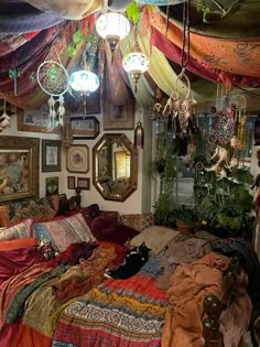 a bed room with a neatly made bed and lots of hanging decorations on the wall