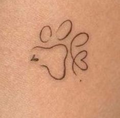 a small tattoo on the back of a woman's arm with an animal symbol