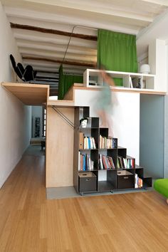 there is a book shelf under the stairs