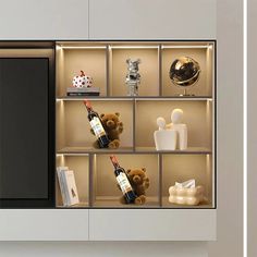 there is a wine bottle and other items on the shelves in this display case with glass doors