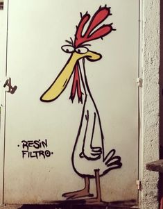 a drawing of a bird with red hair and yellow beak on the side of a building