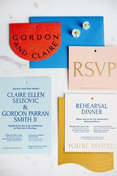 the wedding stationery is laid out on top of each other