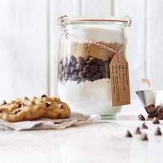 cookies and milk in a jar with a tag on the lid sitting next to it