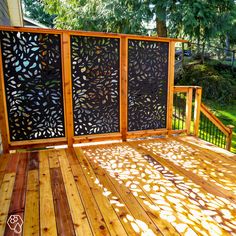 a wooden deck with laser cut screens on it