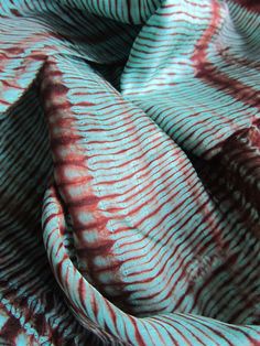 a red and white striped fabric is shown in close - up view on the surface