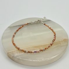 Embrace the calming energy of this micro beaded peach aventurine bracelet. Known for promoting creativity and emotional balance, peach aventurine is thought to encourage optimism and relieve stress. The soft, warm tones of the stone are complemented by a sterling silver extension, offering a versatile fit. Wear it to bring a sense of tranquility and positivity to your day while adding a touch of subtle elegance to your look APPROX. SIZE: 7" with 1 1/2" extension  COUNTRY: India  PLEASE NOTE THAT ALL ITEMS ARE UNIQUE AND MAY VARY IN COLOR AND HAVE MINOR IMPERFECTIONS Peach Aventurine, Aventurine Bracelet, Subtle Elegance, Emotional Balance, Beaded Bracelet, Favorite Jewelry, Jewelry Bracelets, Sense, Im Not Perfect