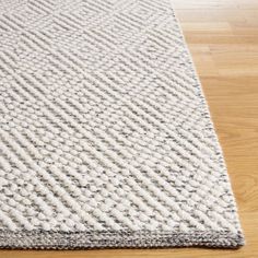 a white rug on top of a wooden floor