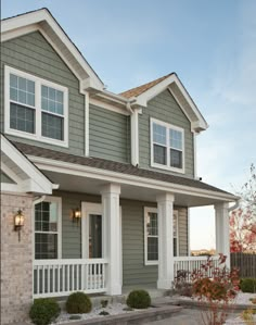 a gray house with white trim and windows