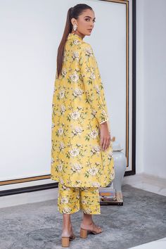 A breezy canary yellow silhouette is the perfect balance of print on print. Finished with a scallop lace detailing on the sleeves and a collared neckline, this raw silk co-ord set is your go to summer staple. Summer Silk Floral Print Pant Set, Spring Silk Pant Set With Printed Motifs, Summer Silk Pant Set With Floral Print, Yellow Palazzo Set With Printed Motifs For Spring, Summer Silk Floral Print Palazzo Set, Yellow Silk Sets With Floral Print, Yellow Silk Floral Print Sets, Yellow Floral Print Silk Sets, Fitted Yellow Palazzo Set With Printed Motifs