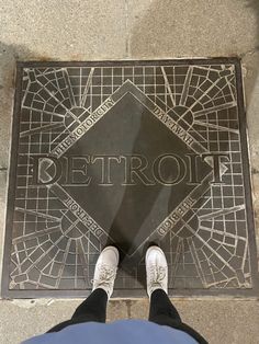 a person standing in front of a sign on the ground