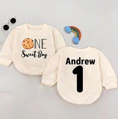 two sweaters that say one sweet boy and the other has a cookie on it