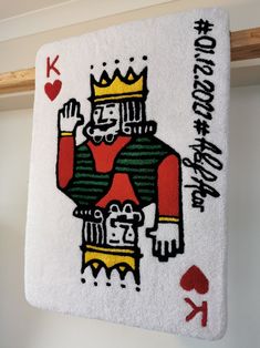 a white towel with an image of a king of hearts on it hanging from the ceiling