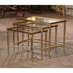 three gold metal nesting tables with glass tops