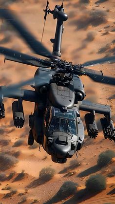 an army helicopter flying through the air over sand dunes in the desert, looking like it is about to take off