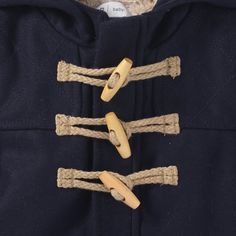 a blue coat with rope and buttons on the front, attached to it's hood