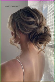 the back of a woman's head, with her hair in a low bun